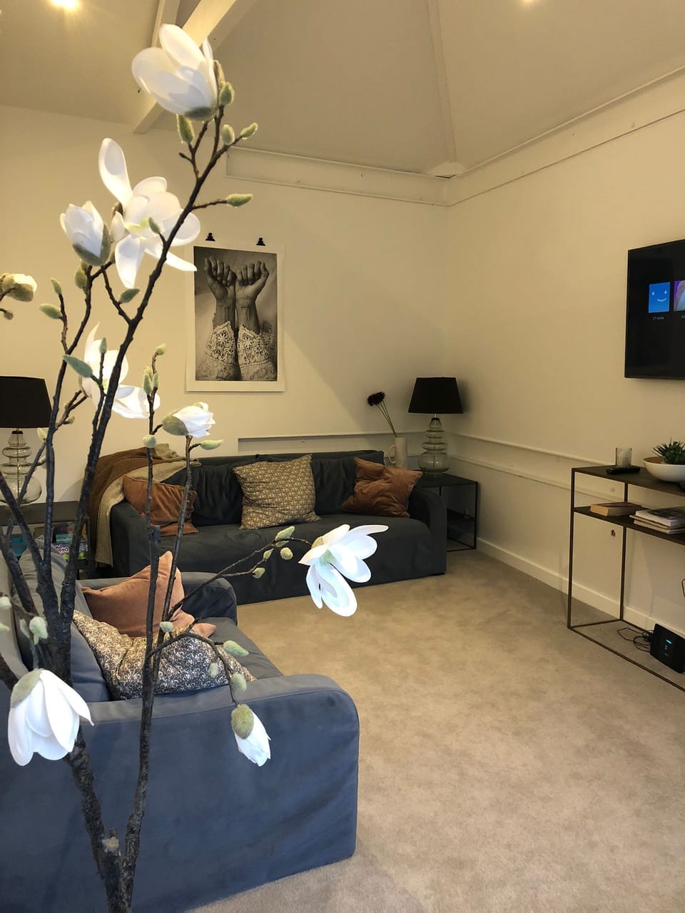 First floor living room with windows overlooking garden and rooftops
