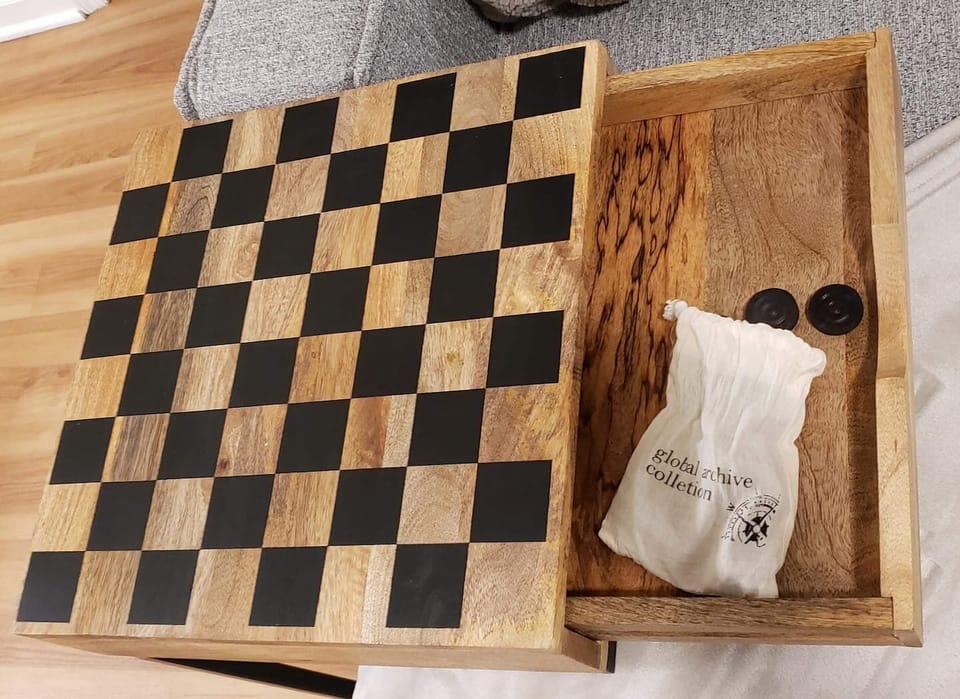 Side table with chess and checkers inside the drawer to challenge your family to a match!

MORE Games and Puzzles!