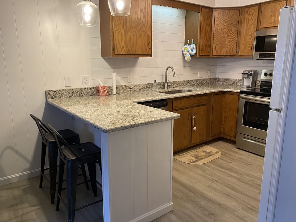Full kitchen with new range, dishwasher, and microwave.