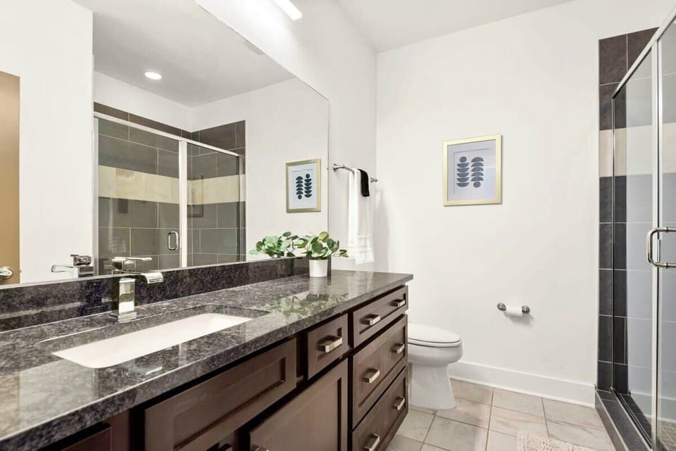 The Hermes room ensuite bathroom offers a single vanity sink and walk in shower.