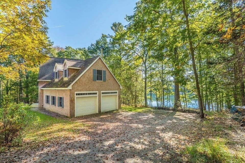 Exterior of the home from the driveway. Enjoy the privacy of the forest.