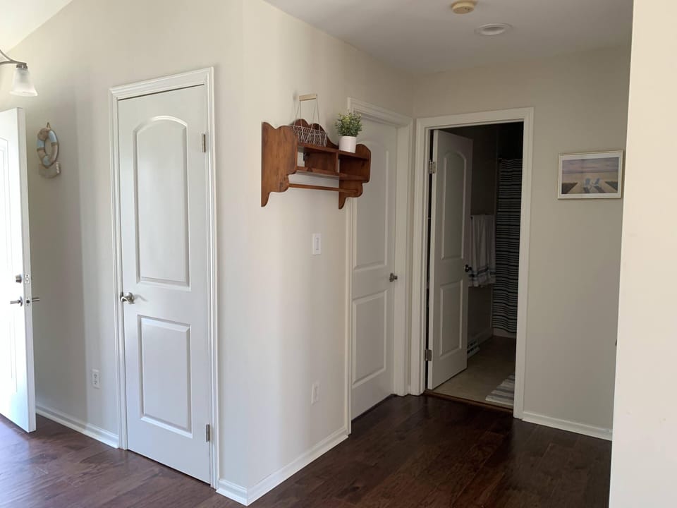 Opening hallway into the main bathroom and two bedrooms on either side