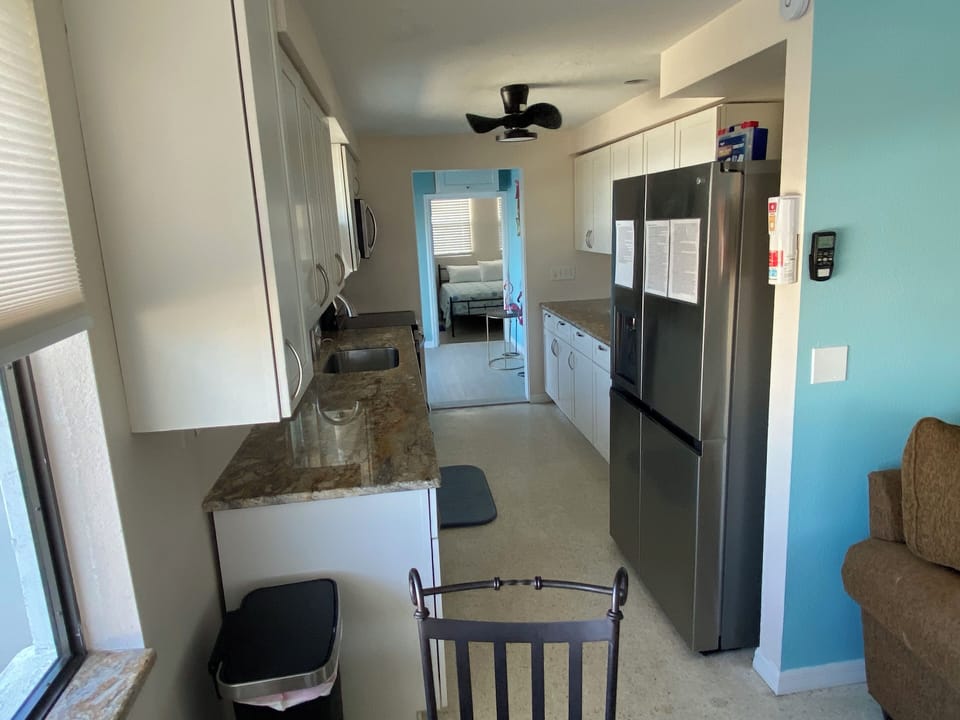 Kitchen view from nook; dishwasher, disposal, 27 cu ft refrigerator