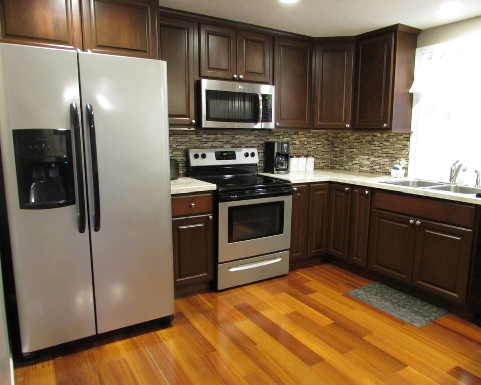 Complete kitchen with refrigerator, microwave, oven, and dishwasher