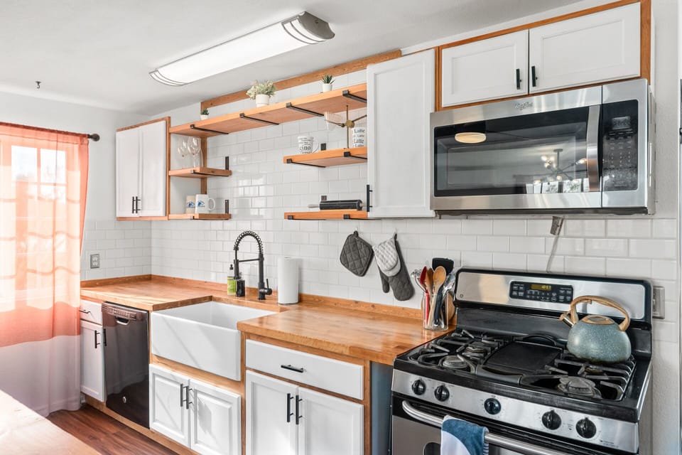 Fully stocked kitchen with over, stove, microwave, fridge and dishwasher