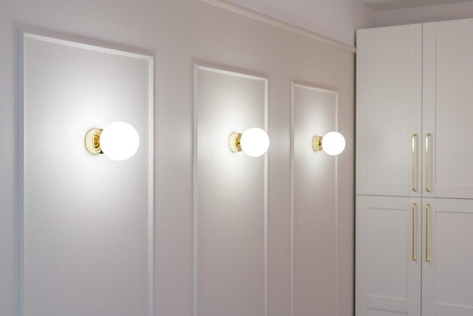 Hallway details with elegant lighting fixtures and bright white walls for a modern feel.
