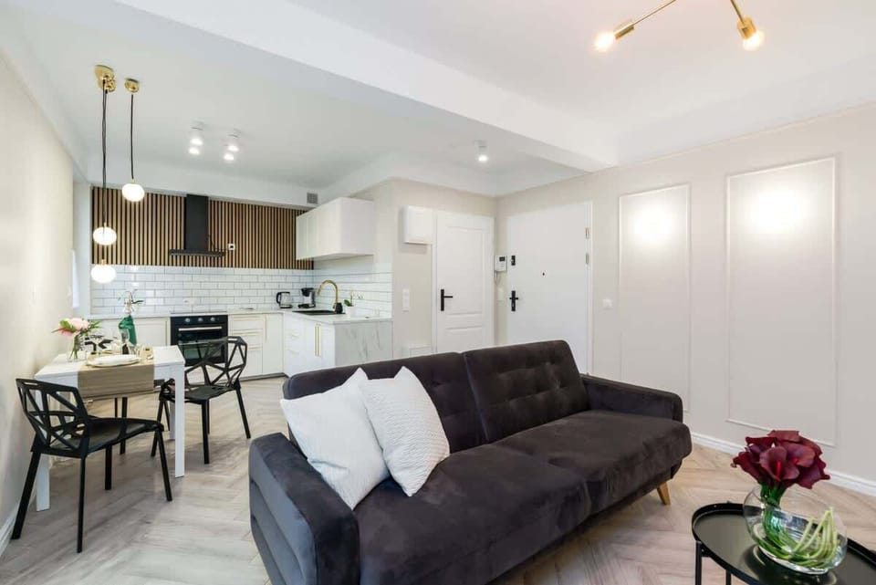 An open-plan living and dining area with stylish furniture and clean, bright finishes.
