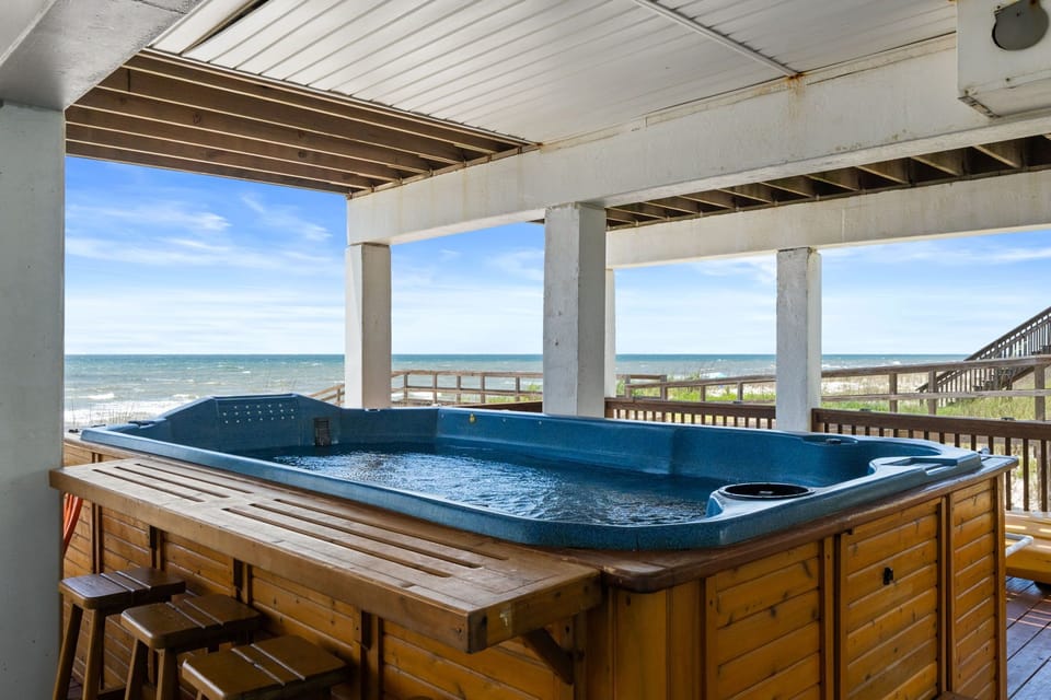 Soak in the swim spa while taking in sweeping ocean views just steps from the sand—your perfect coastal retreat awaits.