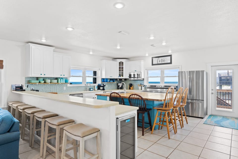 Your dream beach escape starts here—a bright, fully equipped kitchen with ocean views through every window. Gather around the spacious island for morning coffee or prepare meals while soaking in the coastal vibes.