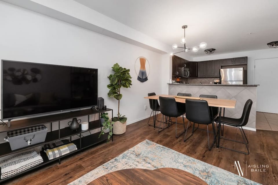 Living room with a Smart TV, high-speed WiFi, cozy couch and walkout access to the private balcony.