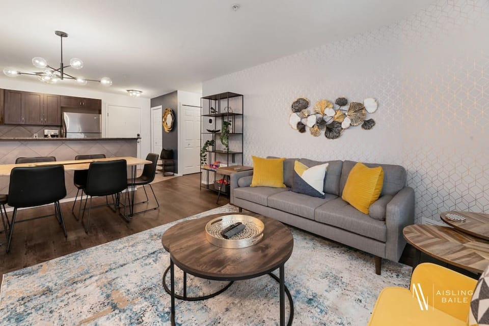 Living room with a Smart TV, high-speed WiFi, cozy couch and walkout access to the private balcony.