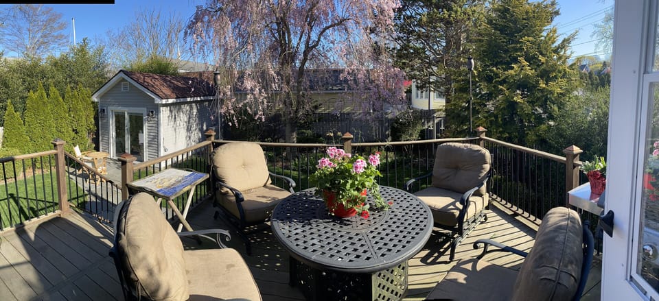 Deck overlooking the landscaped, fenced yard and gardens.