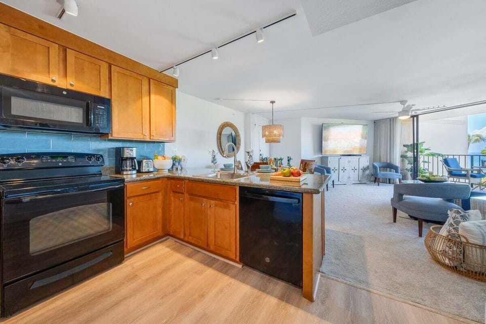 Functional kitchen with black appliances and wooden cabinets