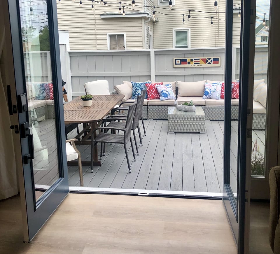 Deck with large sectional, dining table and fire pit (not pictured).