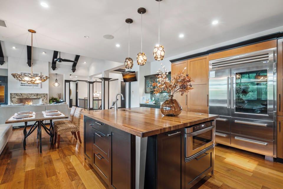 Large kitchen with island, two dishwashers & side by side fridge & freezer.