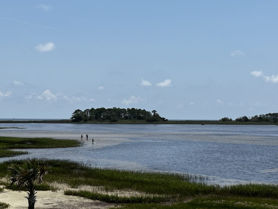Hagen’s Cove. 20 minute ride sandy area with grills picnic tables and bathrooms.