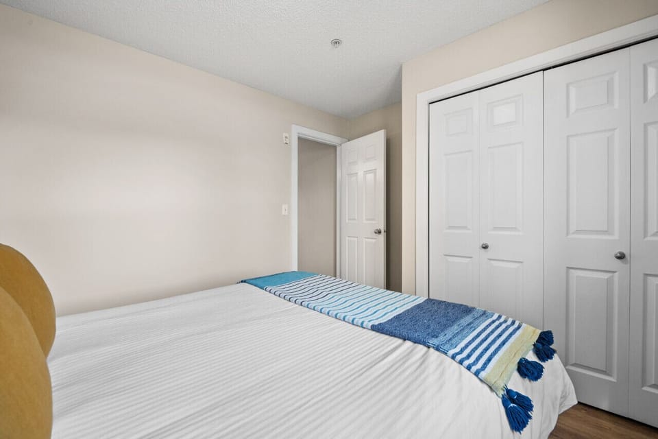 Second bedroom with a queen bed, closet and blackout blinds.