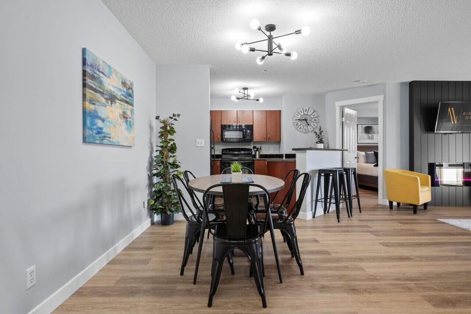 Dining area with seating for 6 at the table and 2 at the island.