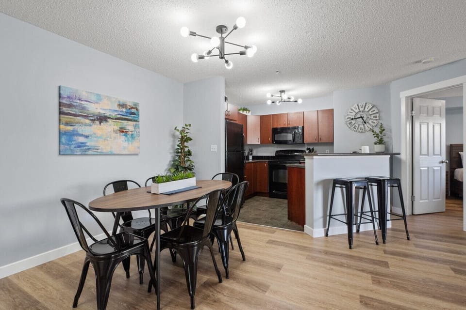 Dining area with seating for 6 at the table and 2 at the island.