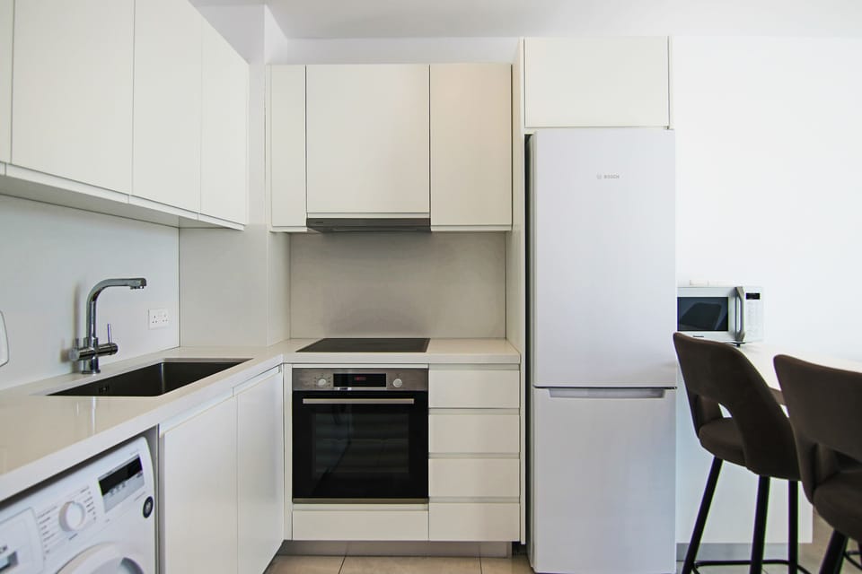 Executive Apartment | Private kitchen | Fridge, electric kettle, highchair, dining tables