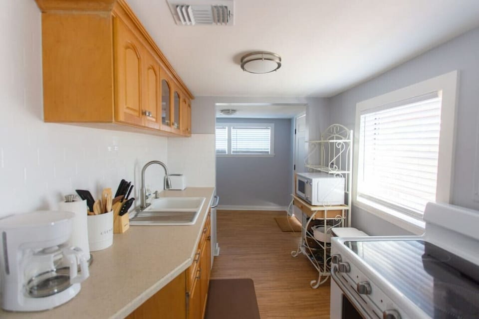 Kitchen includes oven, stop top, microwave, toaster, and coffee maker