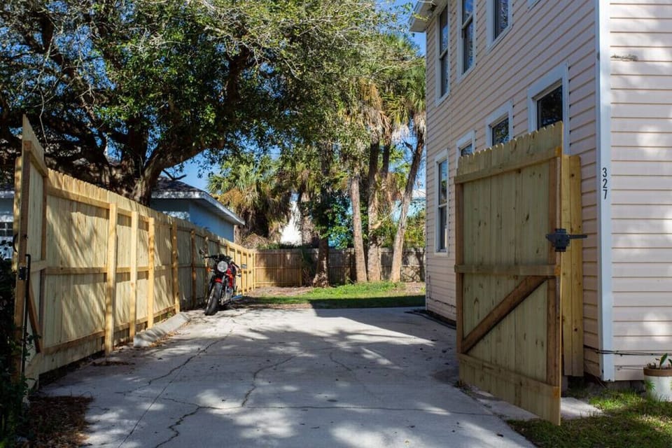 Gated driveway for additional parking. Unfortunately, the motorcycle is not included.