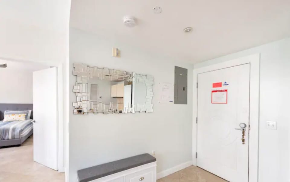 Entrance foyer with a fancy mirror and a useful shoe rack.