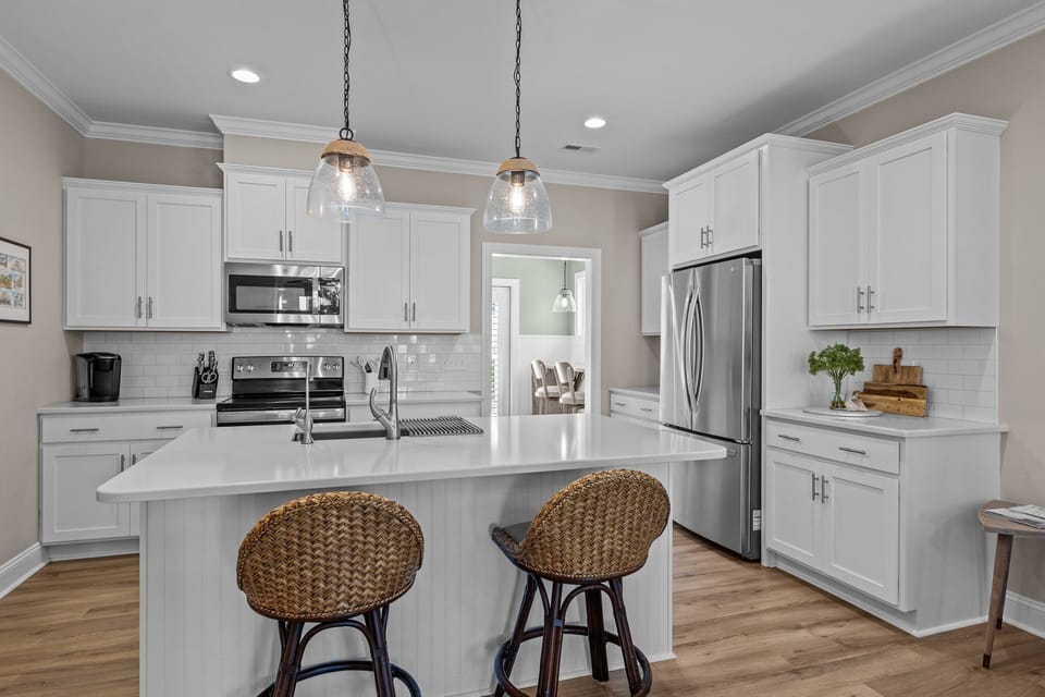 The kitchen has roomy staging that is also an elegant workspace.