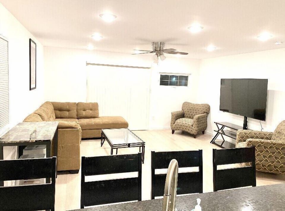 Open concept living room off of Kitchen with balcony