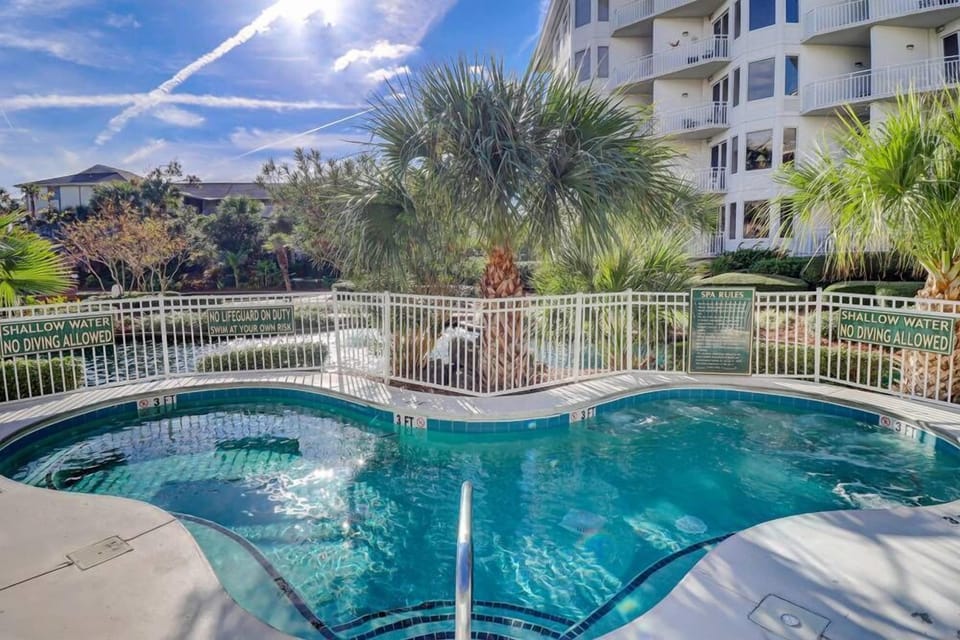 Relax in the outdoor spa surrounded by tropical landscaping and resort-style amenities.
