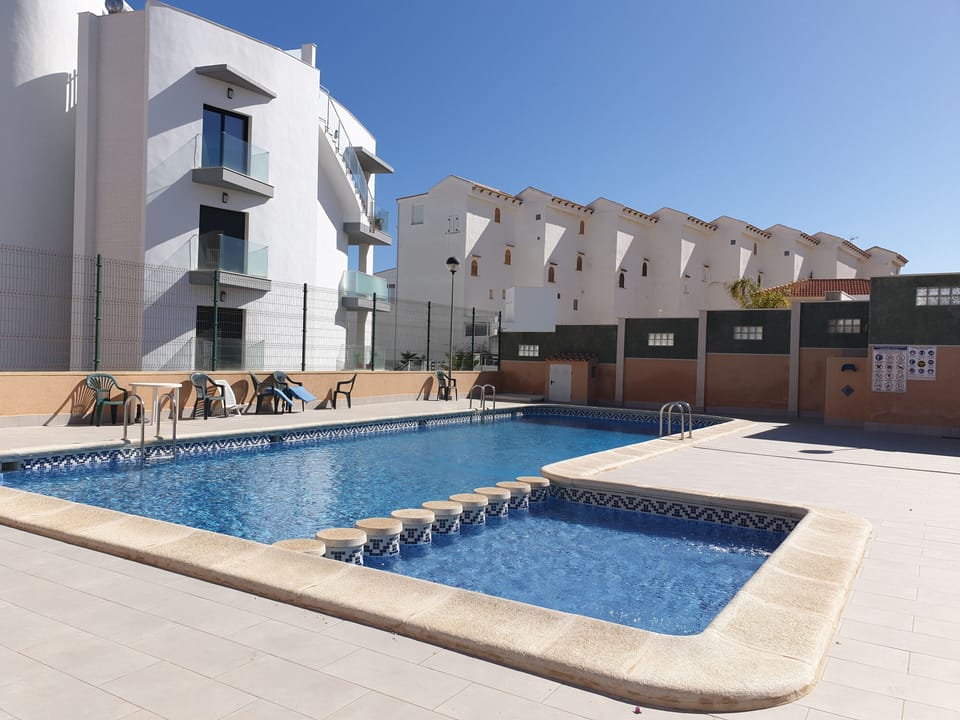 Pool with chairs, recently renovated and a few steps away from the apartment.