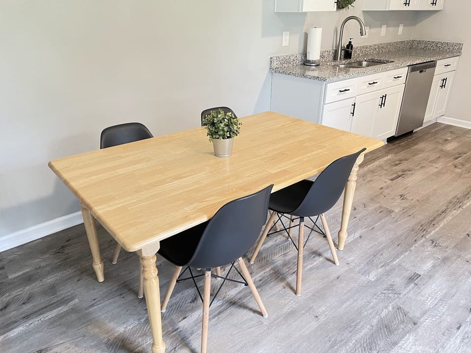 Dining table, seats 6 max, chairs provided.