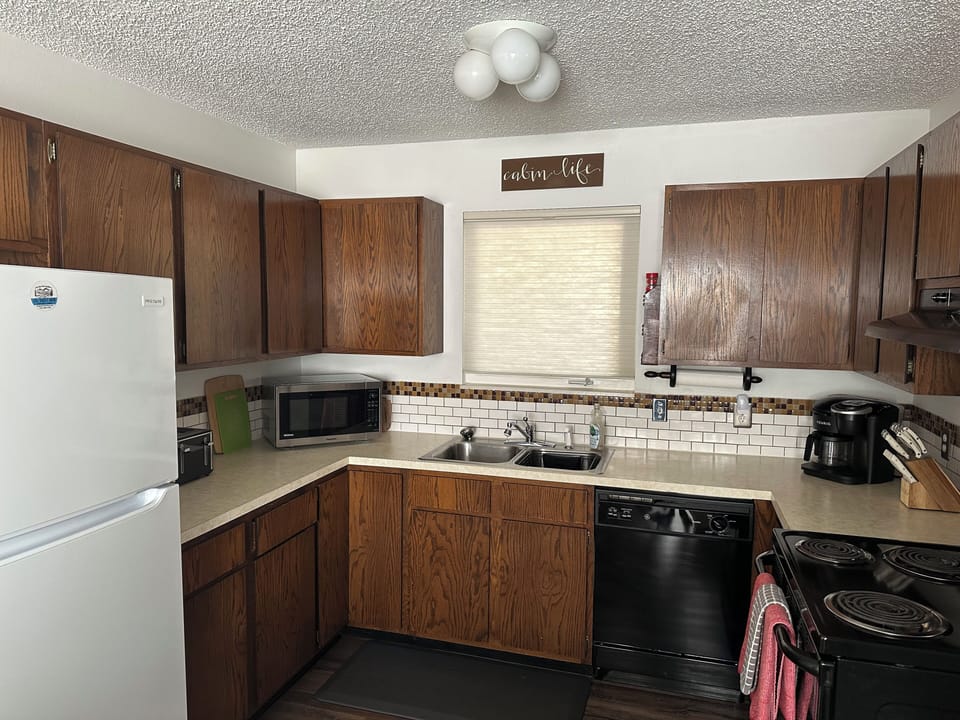 Full kitchen with oven/range, microwave, dishwasher and refrigerator/freezer.