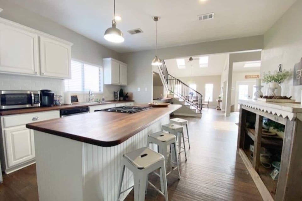 Kitchen is stocked with many cooking, baking and serving items for your family