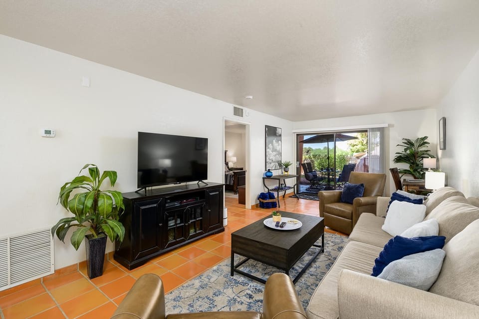 Spacious living room with cozy seating and vibrant natural light