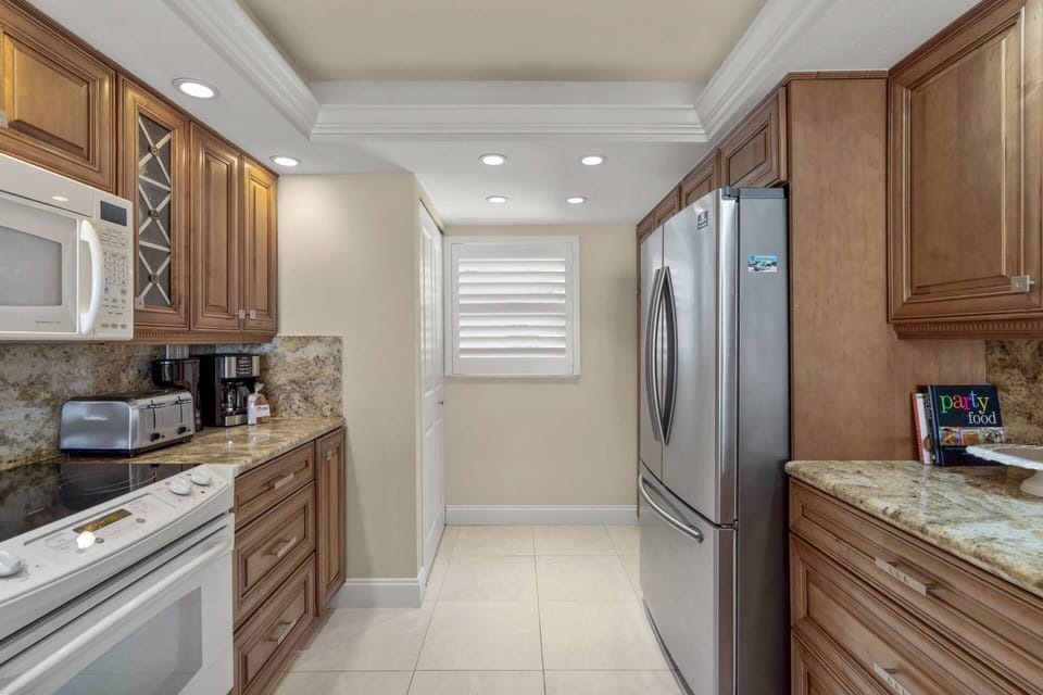 Large kitchen with custom cabinetry and 3 door stainless refrigerator & stainless dishwasher. Easy to cook at home!