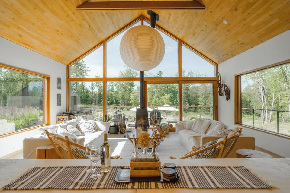 The open concept kitchen and beautiful main living room that looks out over the deck and pollinator meadows.