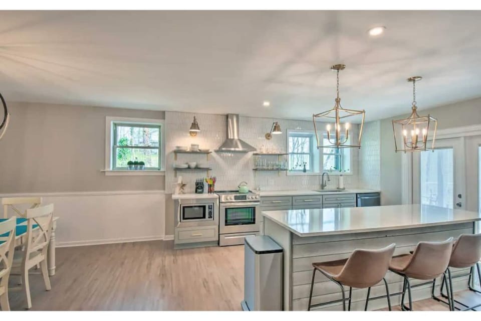Kitchen with 4 chairs at island, 12 pot coffee maker, keurig and cooking spices 