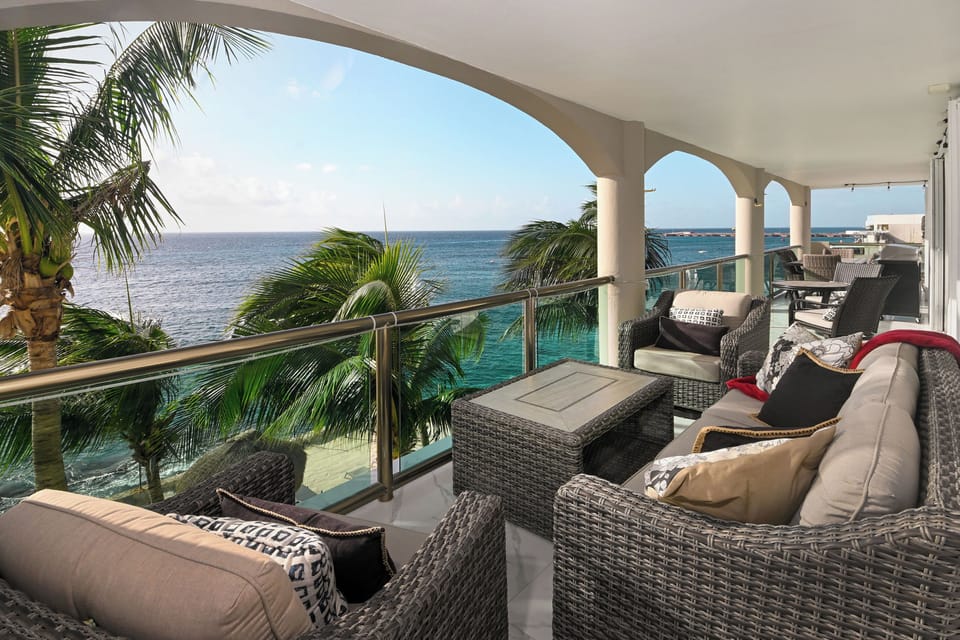 Unwind on your private terrace with panoramic ocean views, tropical palms swaying nearby, and comfortable seating for morning coffee or sunset cocktails.