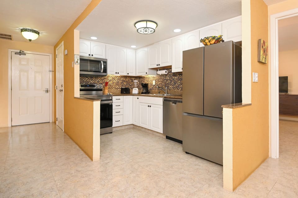 Your fully equipped kitchen features stainless steel appliances and gleaming granite counters, perfect for preparing meals in your home away from home.