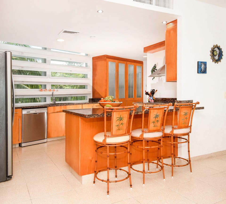 Simple and pristine kitchen equipped with all of your cooking needs