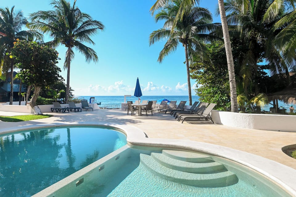 Dive into your private tropical oasis where crystal-clear waters meet powder-soft sand, framed by swaying palms.