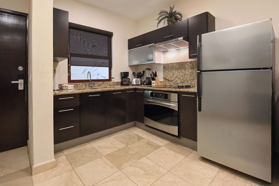 Your sleek modern kitchen features granite countertops, stainless steel appliances, and everything you need to create delicious meals during your stay.