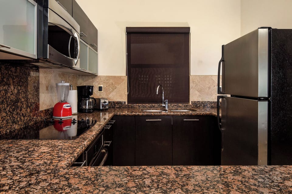 Fully functional, our pristine kitchen features modern appliances for your convenience.