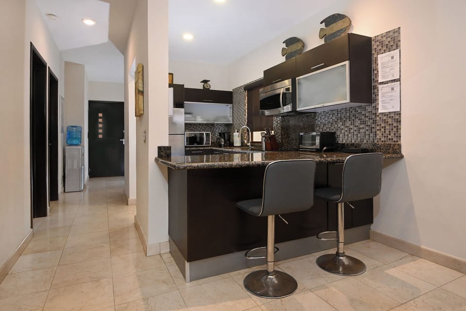 Step into your stylish kitchen, fully equipped with modern appliances, granite countertops, and a welcoming breakfast bar perfect for your morning coffee or casual meals.