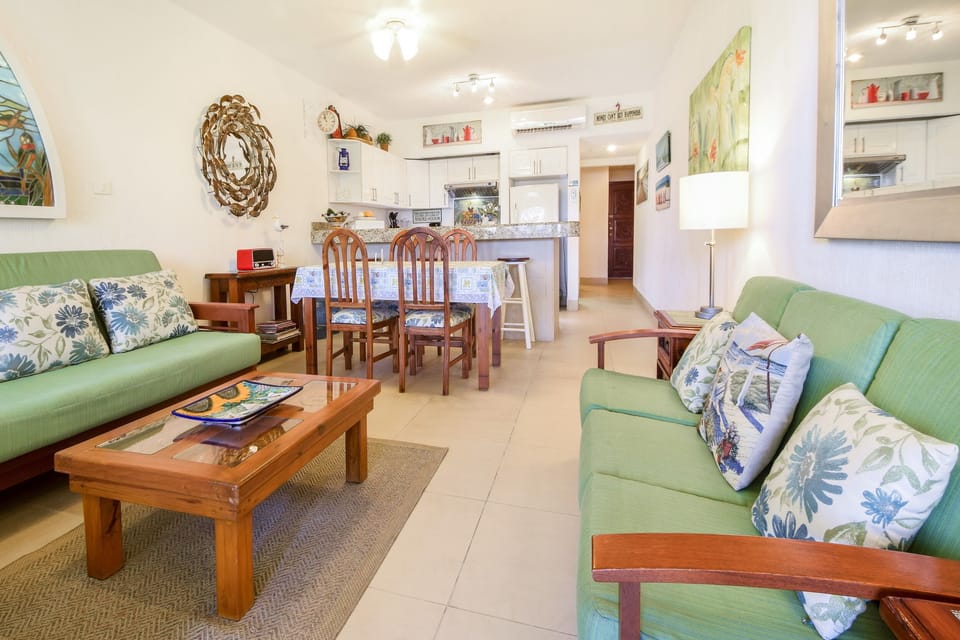 Open dining and living area with kitchen behind