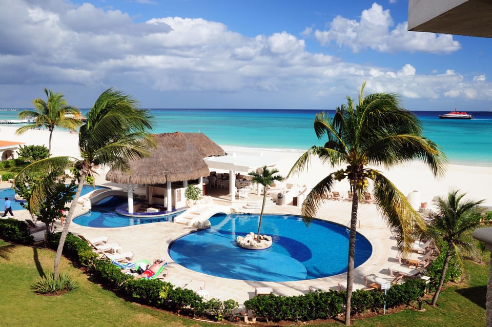 The beautiful communal pool area features shallow section, bridge walkways and swim-up bar