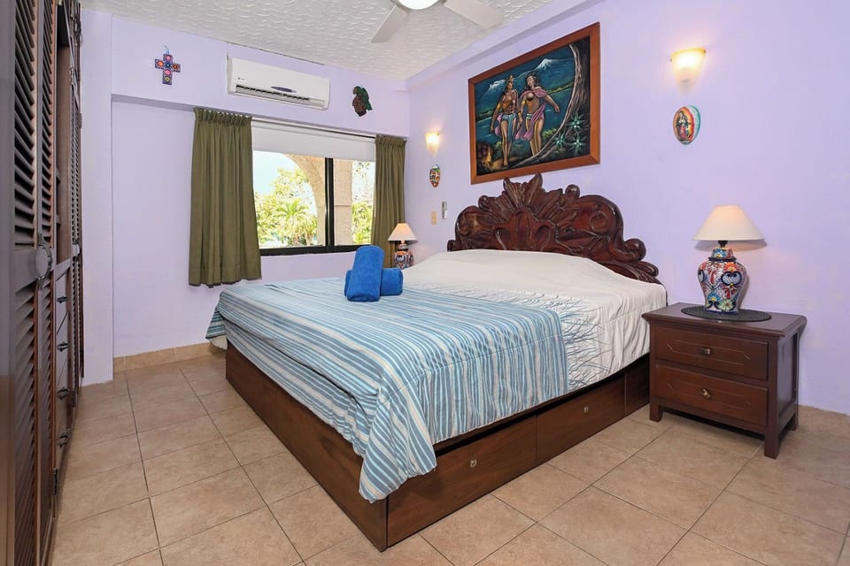 Bedroom with comfy linens, A/C and ceiling fan