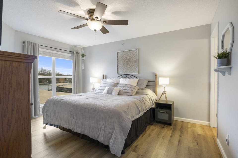 Master bedroom with a view of the lake and it's own door to the deck.
