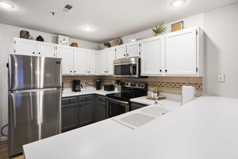 Glass cooktop range, microwave, refrigerator (with ice maker) and dishwasher